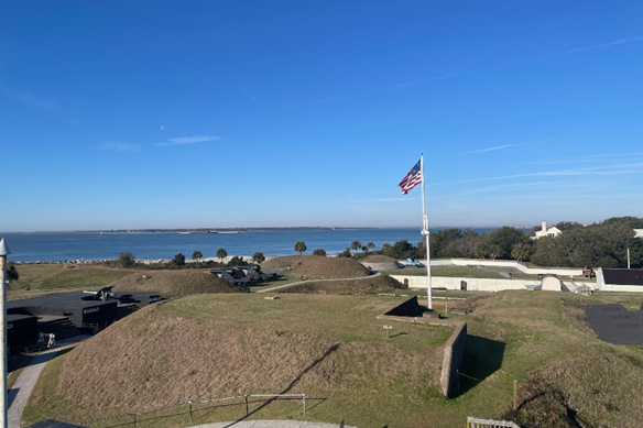 35-star flag flies over Fort Moultrie with Charleston Harbor in the background
